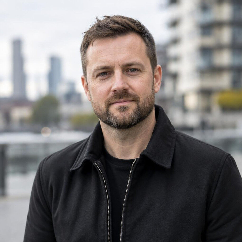 Portrait of a bearded man in his thirties wearing a black jacket